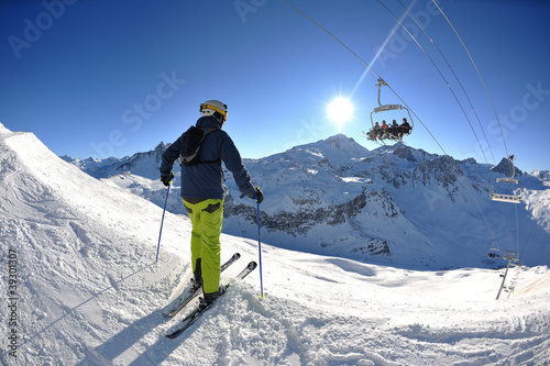 Photo: skiing on fresh snow at winter season at beautiful sunny day skiing on fresh snow at winter season at beautiful sunny day