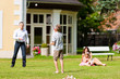 Family is playing in summer in front of their house