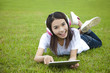young woman using tablet pc on the grass young woman using tablet pc on the grass