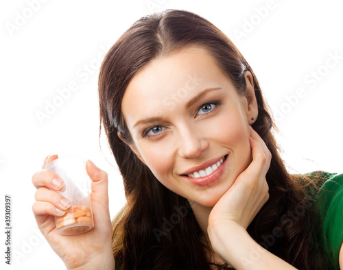 Photo: Woman showing bottle with pills, on white Woman showing bottle with pills, on white