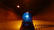 Car With Blue Emergency Light Driving Through A Tunnel