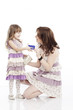 Portrait of mother and little daughter  with a card