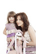 Portrait of mother and little daughter in his arms with a toy