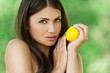 beautiful young woman holding lemon