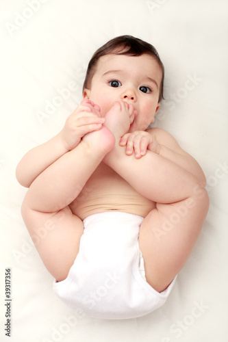 Photo: Adorable baby sucking his toes Adorable baby sucking his toes