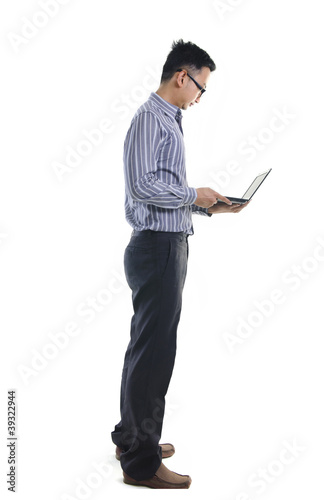 Photo: Young businessman use laptop on white background. Young businessman use laptop on white background.