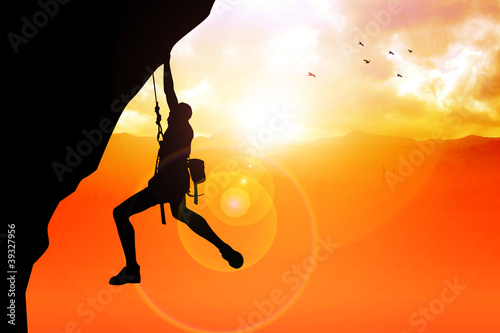 Photo: Silhouette illustration of a man figure hanging on the cliff Silhouette illustration of a man figure hanging on the cliff