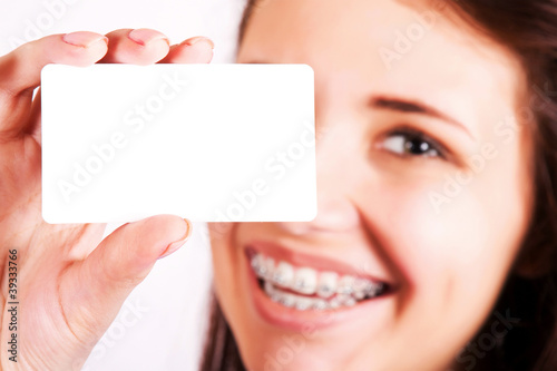 Photo: Girl with braces presenting business card Girl with braces presenting business card