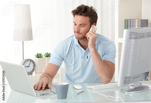 Photo: Casual businessman working in office Casual businessman working in office