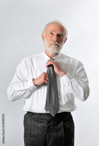 Photo: a businessman fixes his tie a businessman fixes his tie