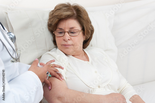 Photo: Doctor giving injection to Senior Patient Doctor giving injection to Senior Patient