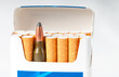 open pack of cigarettes with a weapon cartridge
