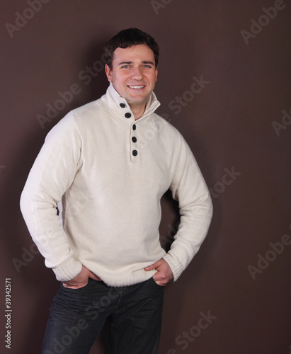 Photo: Handsome man leaning against the wall Handsome man leaning against the wall