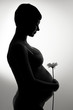 Photo: pregnant woman with flower silhouette pregnant woman with flower silhouette