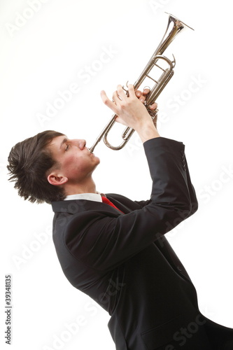 Photo: Portrait of a young man playing his Trumpet Portrait of a young man playing his Trumpet