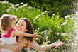Woman with child playing in spring park