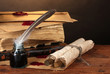 old books, scrolls, feather pen and inkwell