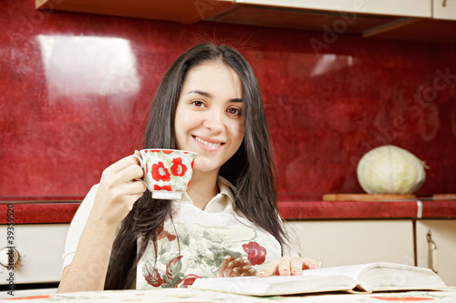 Photo: Housewife with cup and book Housewife with cup and book