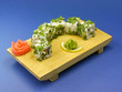 Photo: Delicious sushi on wooden plate. Delicious sushi on wooden plate.