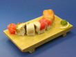 Photo: Delicious sushi with salmon and eel on wooden plate. Delicious sushi with salmon and eel on wooden plate.