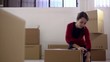 happy woman smiling at home during move with boxes