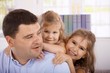 Photo: Father and daughters smiling Father and daughters smiling