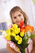 Photo: Cute little girl with bouquet of flowers smiling Cute little girl with bouquet of flowers smiling