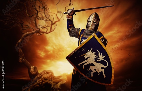 Photo: Medieval knight over stormy sky. Medieval knight over stormy sky.