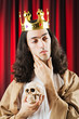 Funny king against red curtain