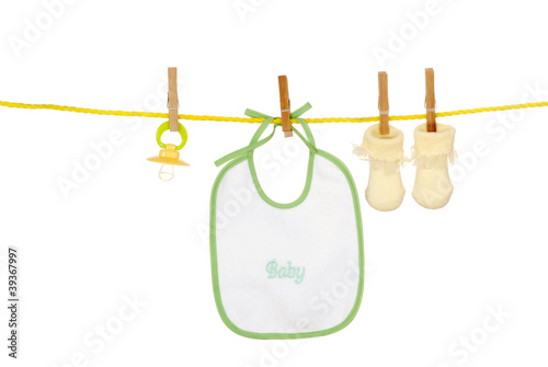 Photo: Isolated baby bib socks on a clothes line Isolated baby bib socks on a clothes line