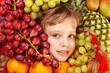 Child girl in group of fruit.