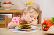 little girl eating? sandwich