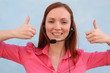 Woman with headset gesturing thumbs up