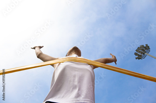 Photo: Winning athlete with cloud background Winning athlete with cloud background