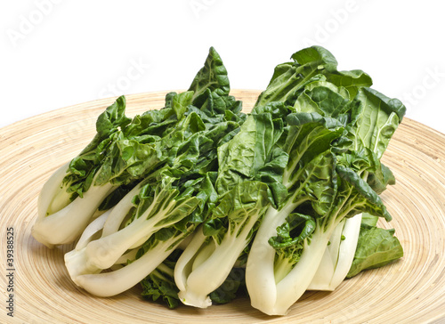 Photo: Bunch of Baby Bok Choy on a Bamboo Tray Isolated on White Bunch of Baby Bok Choy on a Bamboo Tray Isolated on White