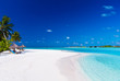 Palm trees over lagoon and white sandy beach