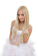 Portrait of beautiful blonde in white dress sitting in an armcha