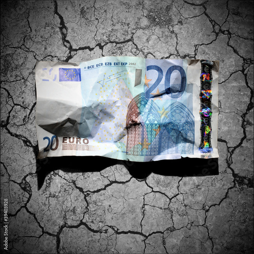 Photo: Crumpled 20 euro banknote on dry soil background Crumpled 20 euro banknote on dry soil background