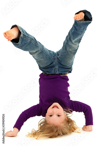 Photo: Beautiful Preschool Girl Child Laughing and Doing Hand Stand Beautiful Preschool Girl Child Laughing and Doing Hand Stand