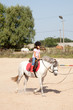 Little Girl Taking Horseback Riding Lessons