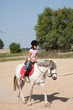 Little Girl Taking Horseback Riding Lessons