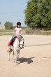 Little Girl Taking Horseback Riding Lessons