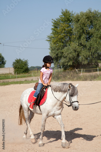 Photo: Little Girl Taking Horseback Riding Lessons Little Girl Taking Horseback Riding Lessons