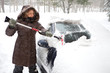 Photo: Woman removing snow from car windshield Woman removing snow from car windshield