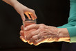 hands of grandmother and grandchild with the glass of water hands of grandmother and grandchild with the glass of water