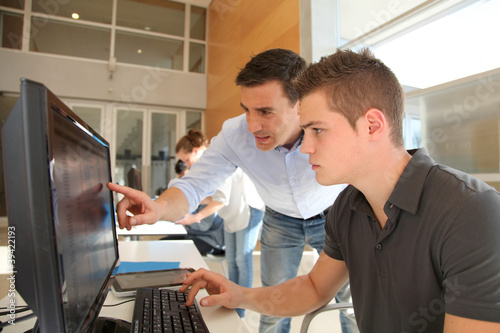 Photo: Teacher and student working on computer Teacher and student working on computer