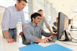 Students with teacher in front of desktop computer