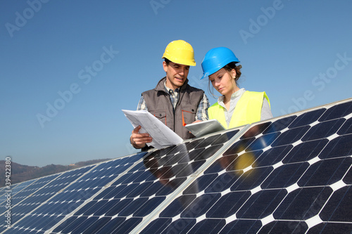 Photo: Man showing solar panels technology to student girl Man showing solar panels technology to student girl