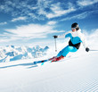 Skier in mountains, prepared piste and sunny day
