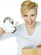 Blonde woman is preparing a package for dispatch